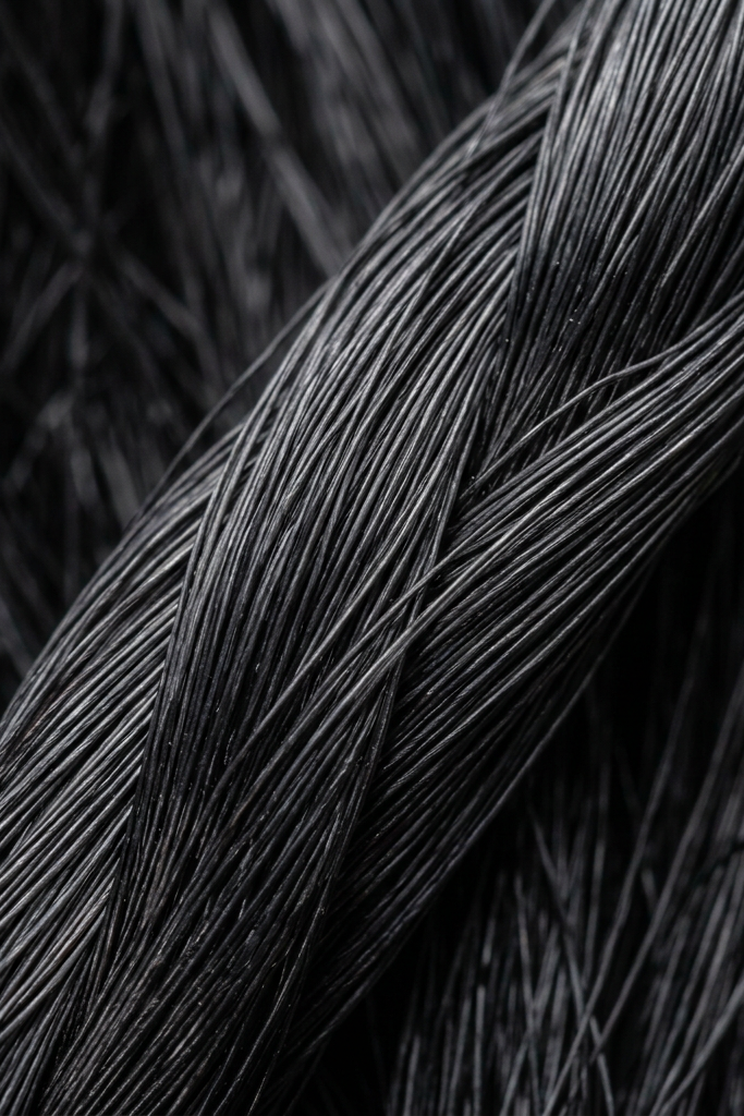 Tightly braided strands of black fibers with fine texture